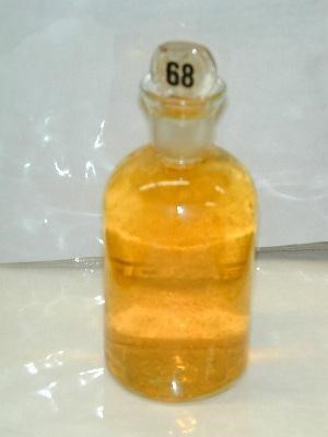 Chemical reagent in amber glass bottle, used in laboratory experiments for substance analysis.