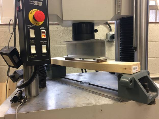 Material stress testing; bending test; mechanical properties; wooden beam; laboratory setup.